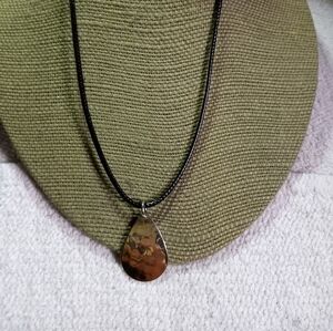 Goldtone teardrop pendant on black cord necklace